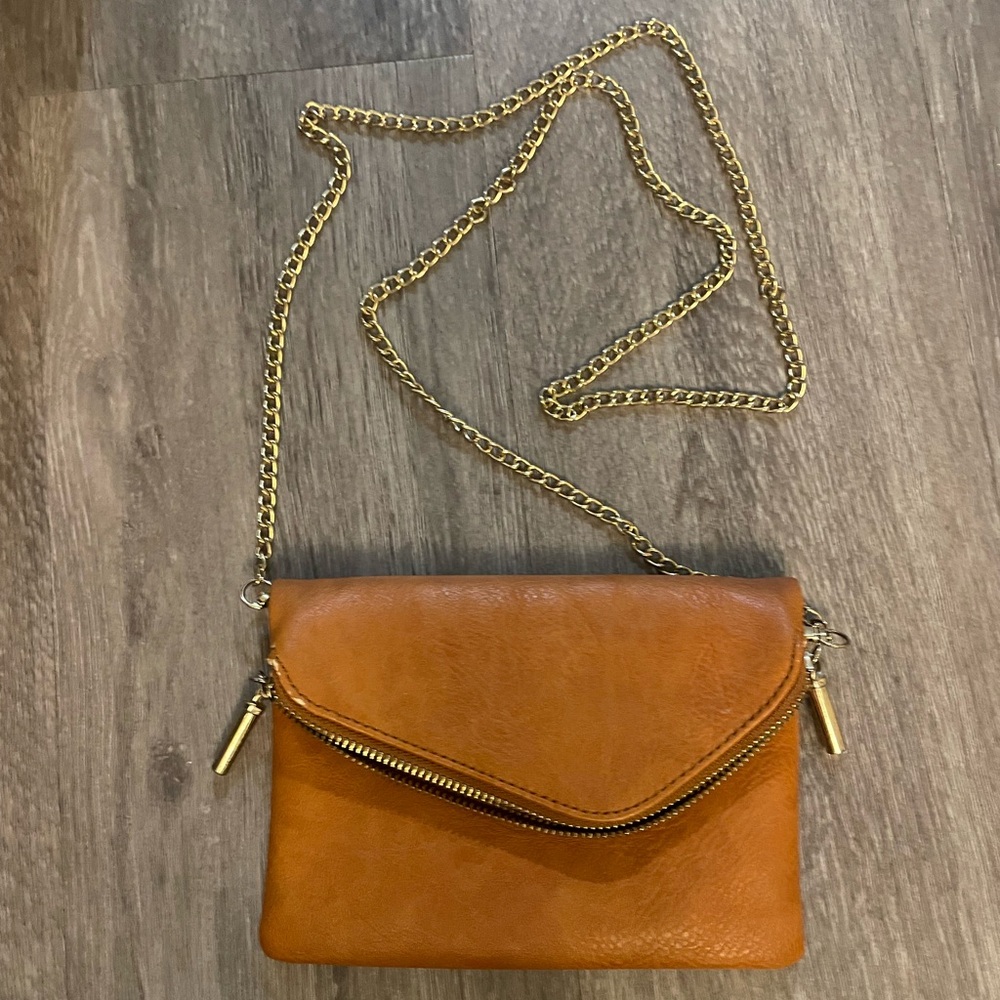 Crossbody purse with gold strap, credit card slots inside.